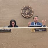 Scottsdale City Councilmember Solange Whitehead and Mayor David Ortega sit behind a desk during a city council meeting.