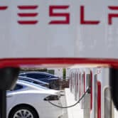 Three Tesla vehicles charge at a station in California.