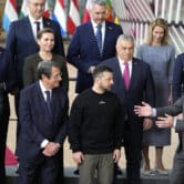 Various European leaders prepare to pose for a group photo in Brussels.