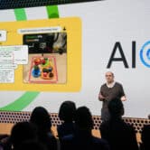 A Google executive speaks on stage in front of a small crowd during an artificial intelligence event in New York.