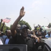 Atiku Abubakar waves to supporters as they protest in Abuja, Nigeria.