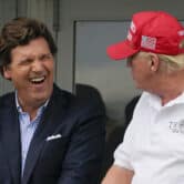 Tucker laughing beside Donald