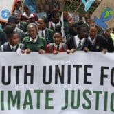 Young people hold a sign reading, "YOUTH UNITE FOR CLIMATE JUSTICE" during a protest in Cape Town, South Africa.