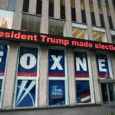 Text reading "President Trump made election-eve visit" is displayed on a screen outside Fox News studios.