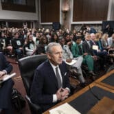 Howard Schultz testified during a Senate committee hearing with dozens of people seated behind him.