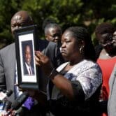 Irvo Otieno’s mother holds a portrait of her son.