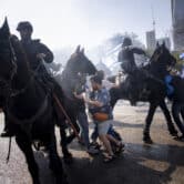 Israeli police deploy horses and stun grenades to disperse a protest.