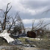 A home is damaged and trees are knocked over after a tornado swept through Little Rock, Arkansas.