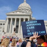 Protesters hold signs in support of transgender care for minors at the Missouri State Capitol on March 29, 2023. (Credit: Be Lovely Photography.)