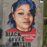 A large ground mural depicting Breonna Taylor above the words "Black Lives Matter."