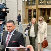 E. Jean Carroll is exiting Manhattan federal court with her arm around her attorney Roberta Kaplan