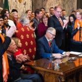 Washington state Governor Jay Inslee signing three gun safety bills into law.