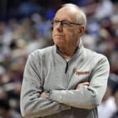 Jim Boeheim crosses his arms during a men's college basketball game.