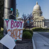 A torn sign reading "my body, my choice" is taped to a streetlight near the Idaho state Capitol.
