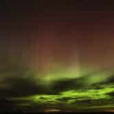 Northern lights are seen in the night sky.