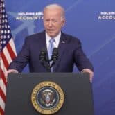 President Joe Biden speaks behind a podium.