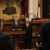 Texas lawmakers debating at podium