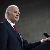 Joe Biden rests his hand on a lectern during a speech.
