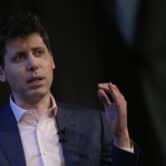 Sam Altman gestures while speaking at an event.