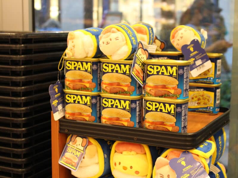 Spam cans with cat plushies stacked on top