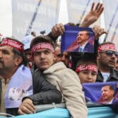 Turks listen to President Recep Tayyip Erdoğan during a campaign rally in Ankara.