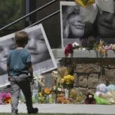 A memorial with flowers and photos of children.
