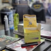 A pack of fentanyl test strips on top of magazines on a table in a barbershop.