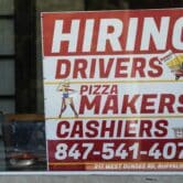 A hiring sign is displayed at a restaurant in Buffalo Grove, Illinois.