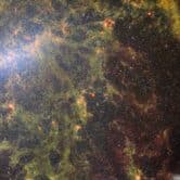 a green web of stars and dust in outer space