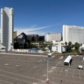 Parking lot with hotels and casinos in background.