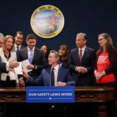 California Governor Gavin Newsom signs gun safety bills.