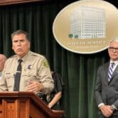 LA County Sheriff Robert Luna, left, and District Attorney George Gascon, right, at a press conference to announce murder charges being field against the man accused of killing a sheriff's deputy