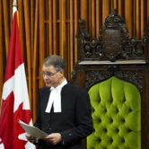 Anthony Rota holds papers while standing in Canada's House of Commons.