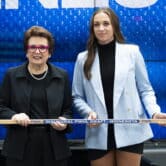 Billie Jean King and Taylor Heise hold a hockey stick during the inaugural Professional Women's Hockey League draft.