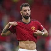 Bruno Fernandes lifts his Manchester United jersey during a men's soccer match.