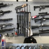 A variety of guns, including shotguns and rifles, on display at a gun shop.