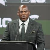 Mel Tucker stands behind a podium during a news conference.