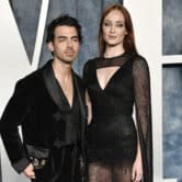 Joe Jonas and Sophie Turner pose wearing formal outfits.