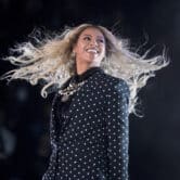 Beyoncé smiles while performing during a concert.