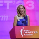 Cathy Engelbert stands behind a podium during the 2023 WNBA basketball draft.