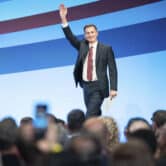Jeremy Hunt waves as he walks on stage during a Conservative Party conference.