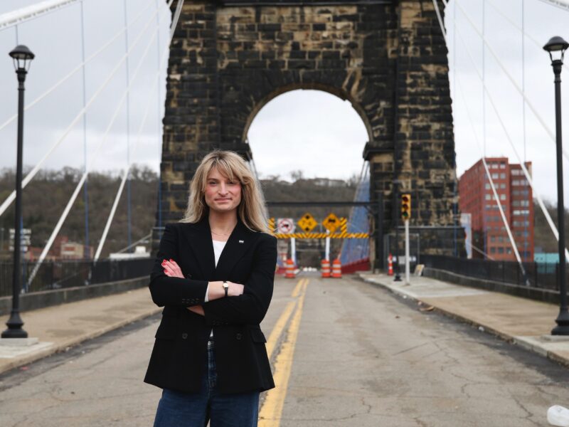 Rosemary Ketchum stands with her arms crossed while posing for a photo on a closed-down bridge.