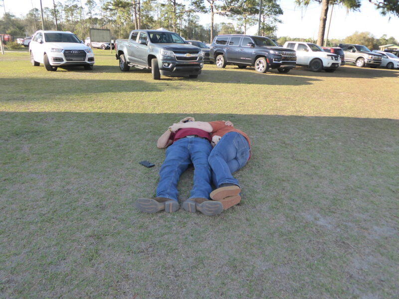A couple lay on the ground at the county fairgrounds