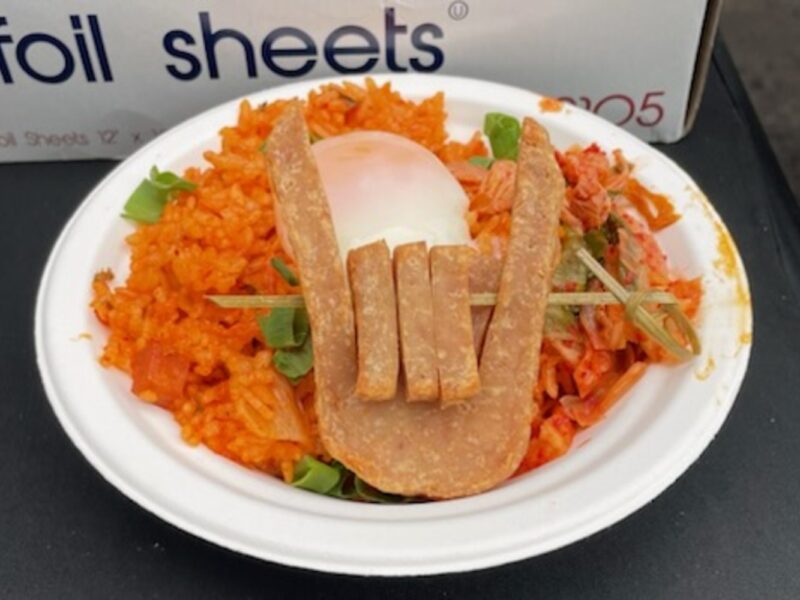 A plate of fried rice mixed with diced Spam and kimchi, showcasing the Korean-Hawaiian fusion dish.