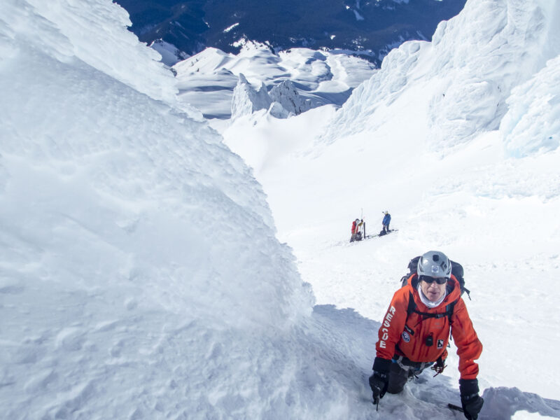 A man climbs snowy slopes.