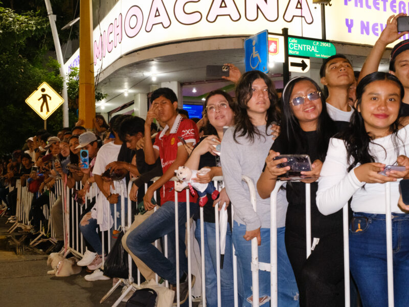 Young men and women crowd the gates in Tuxtla, Chiapas.
