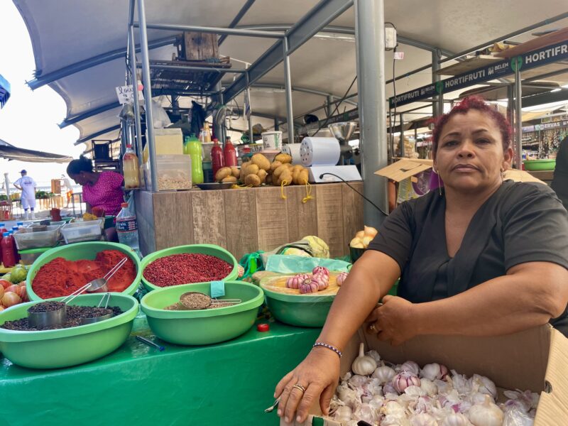 Graciete Morais sits behind a stall with garlic and spices at Ver-o-Peso market in Belem.