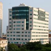 A large federal building in Miami with sunny skies