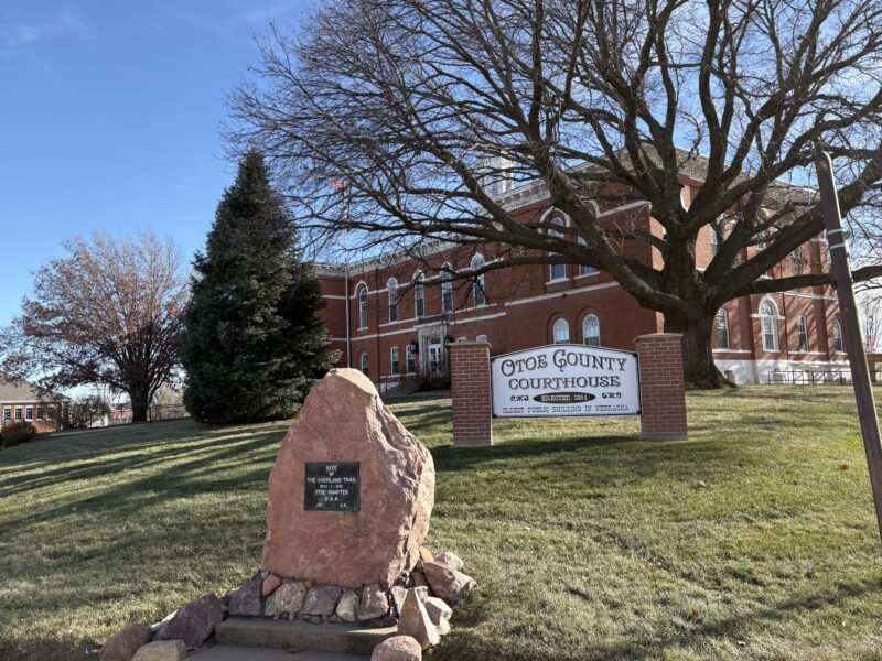 A brick 19th century government building on a hill