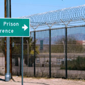 A sign points in the direction of the Arizona State Prison in Florence, Arizona